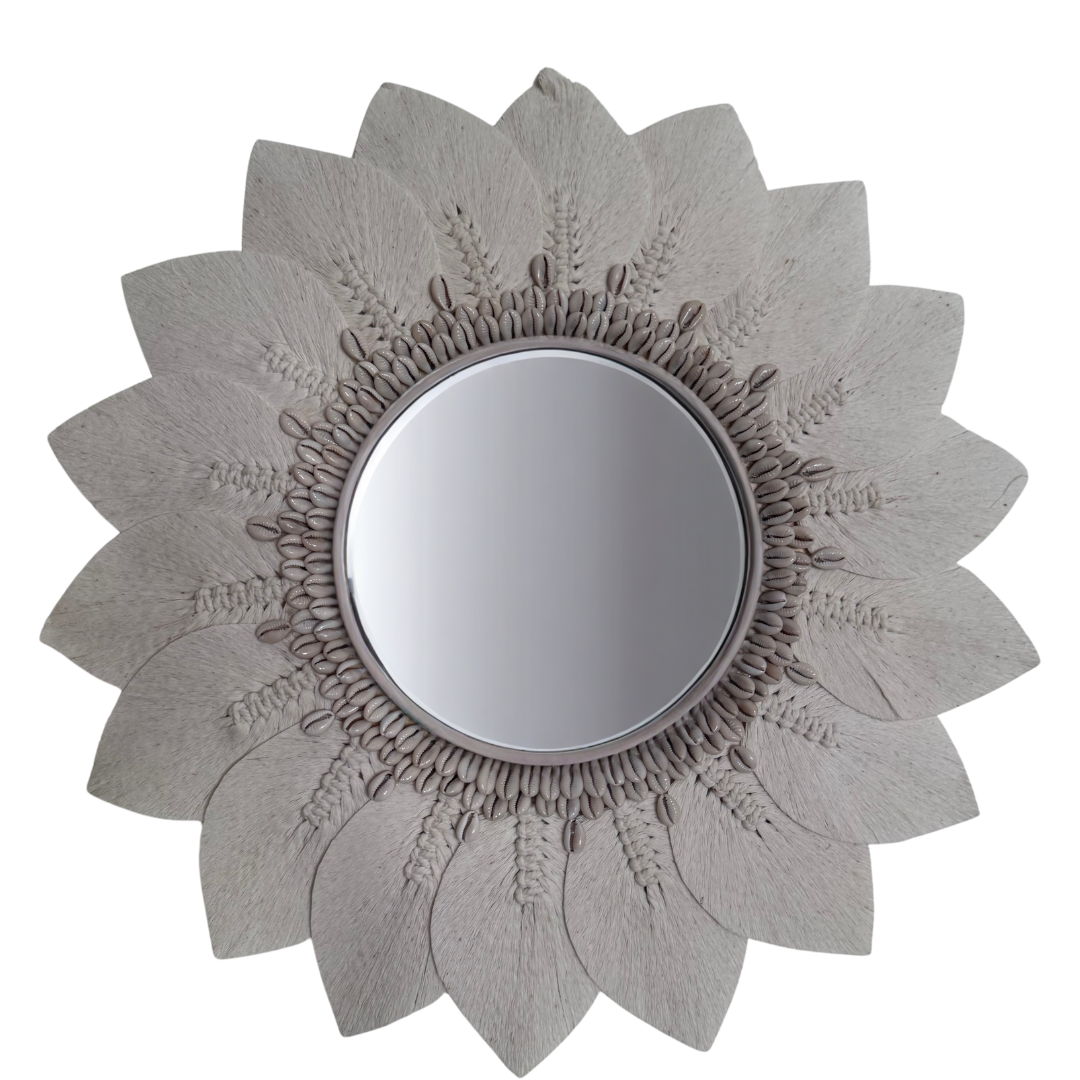 Round decorative wall mirror with a cream sunflower-shaped woven frame on a white background