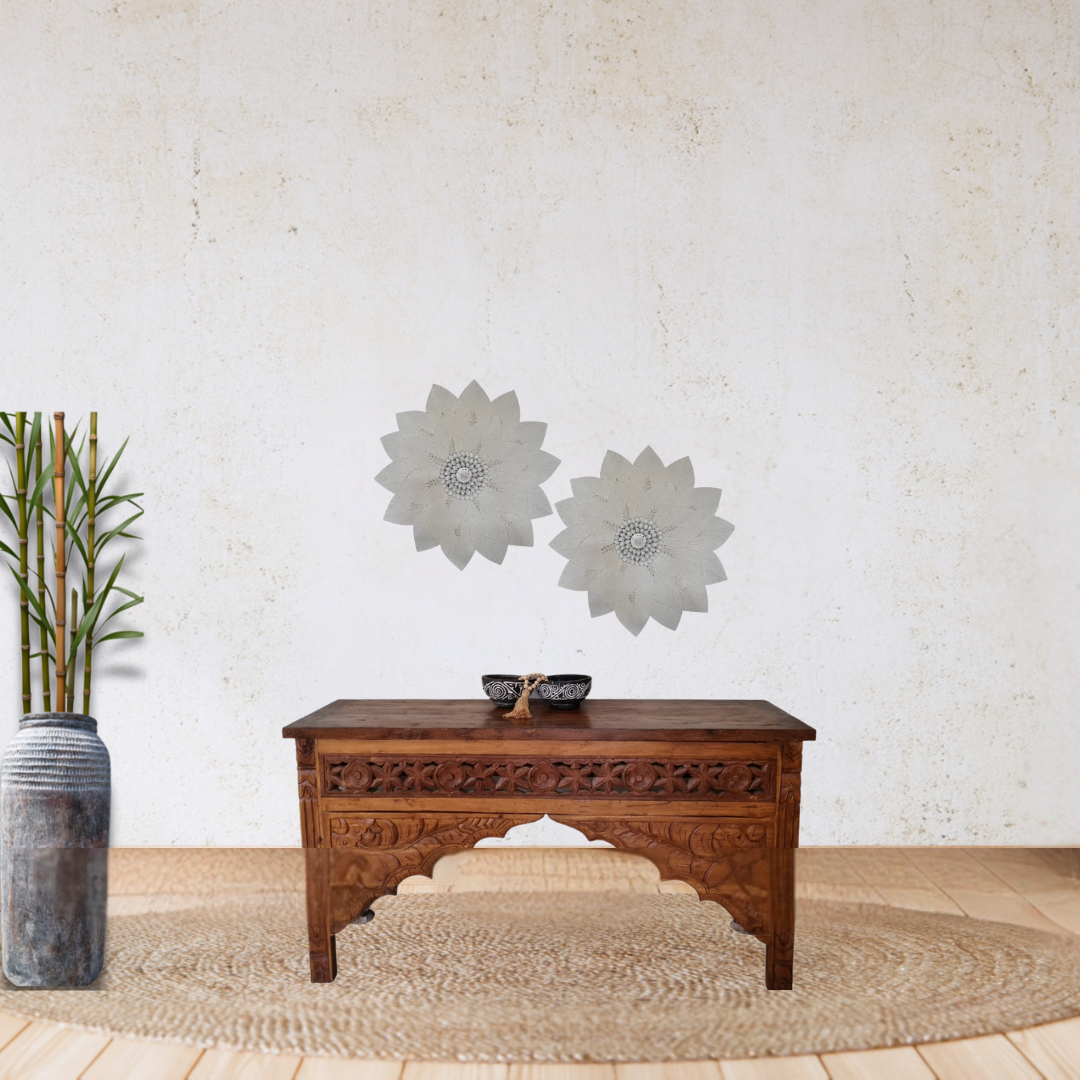 Wooden console table styled with decorative macramé décor against a white wall featuring floral wall art, boho coastal home styling.