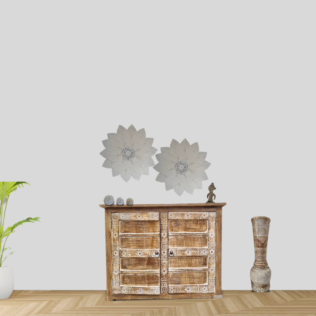 Wooden cabinet styled with decorative macramé wall art and a vase against a light grey background, boho coastal home décor.