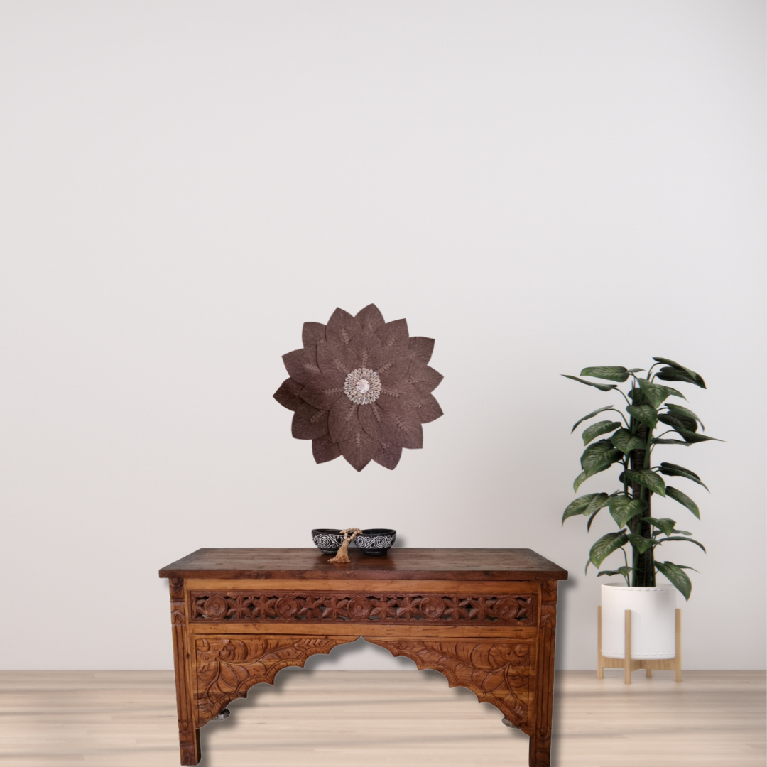 Brown macramé floral leaf wall art with cowrie shell centre detail styled above a Balinese console table with plant in neutral living room – handcrafted boho coastal décor Australia