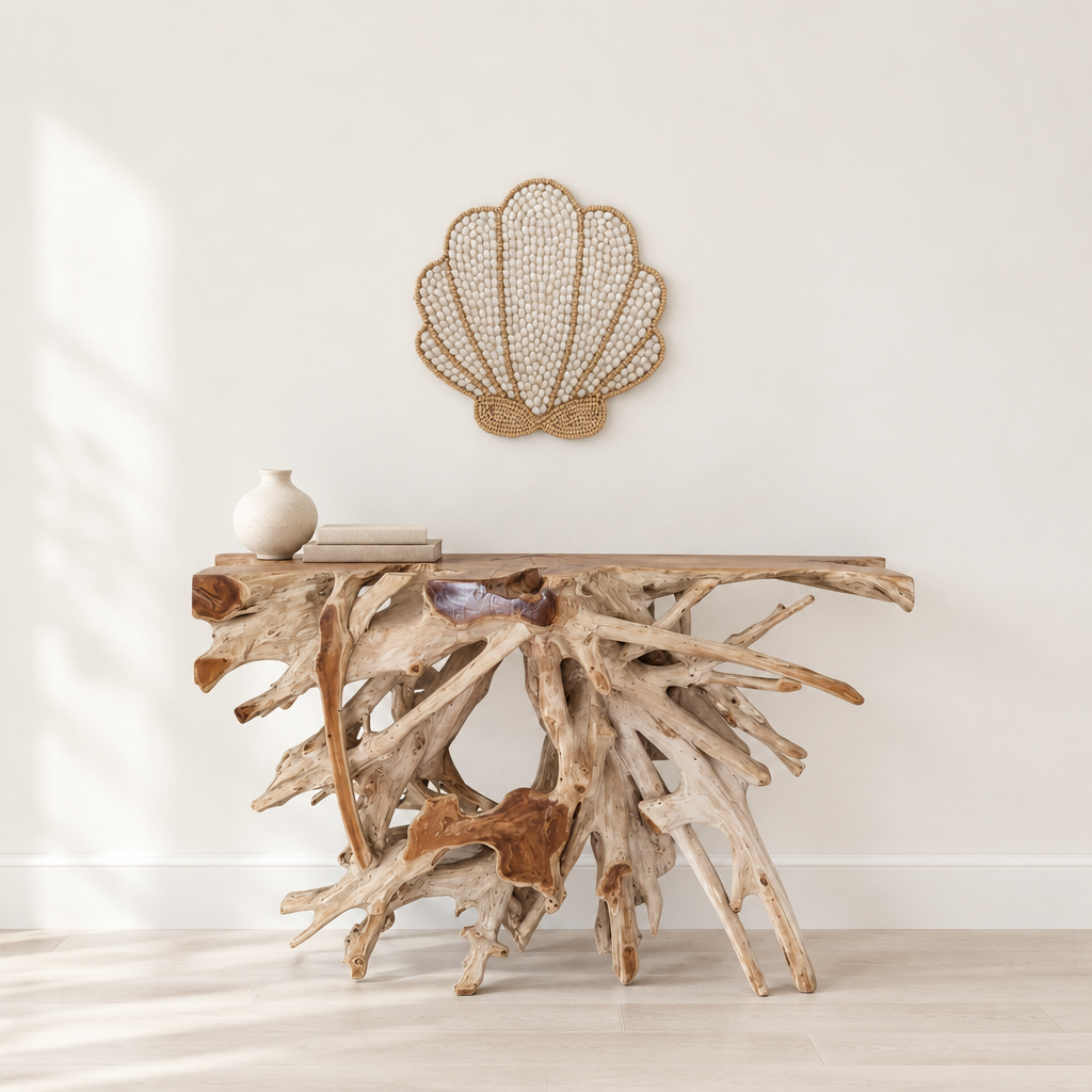 coastal style wall hanging set on a  above a natural teak root console table with a cream vase