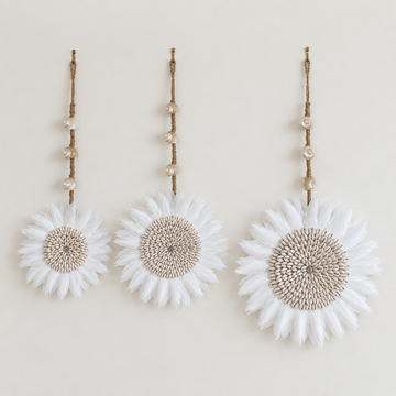 Three sizes of long stem juju hats hung side by side, 23cm, 27cm and 37cm feather discs with 55cm to 65cm drops.