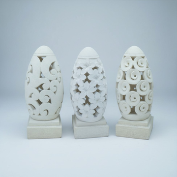 Three handcrafted concrete garden lanterns from the Dome Collection – Spiral, Frangipani, and Circular motif styles – displayed on square bases against a soft grey background.