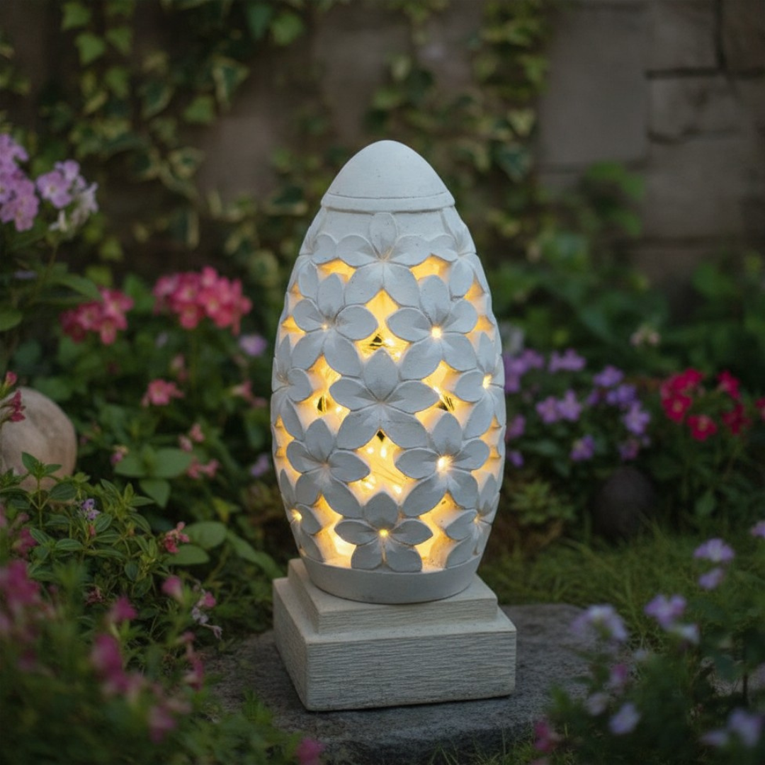 Decorative outdoor unsing solar outdoor lighting with frangipani patterns in a garden setting