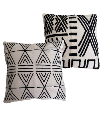 Two decorative pillows with geometric black patterns on a white background