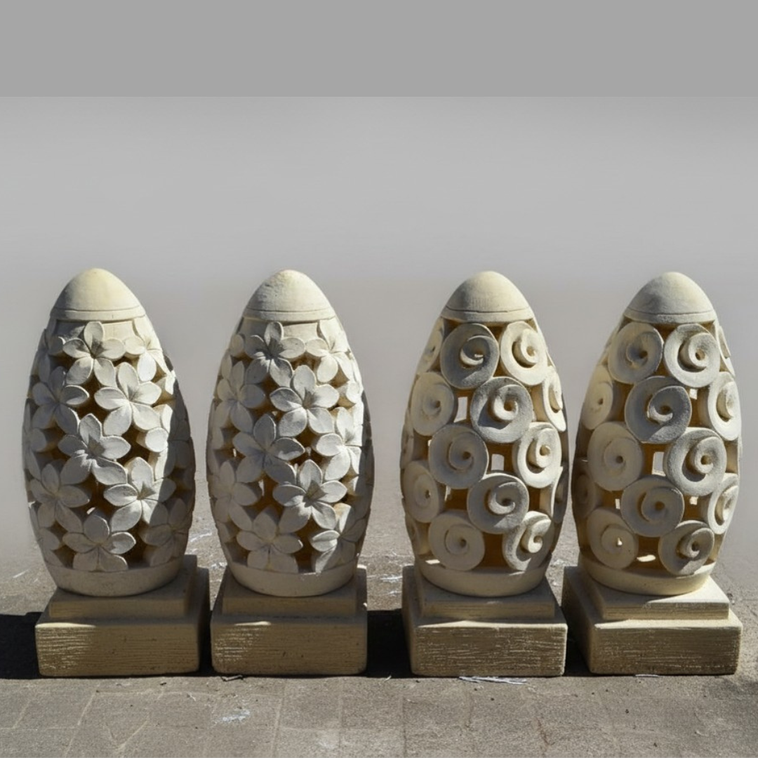 Four decorative stone dome style lanterns with intricate carvings on a plain background