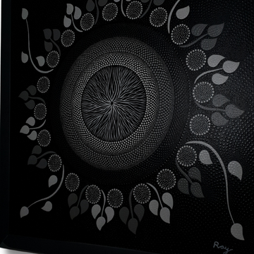 angle shot A dot art painting on a dark canvas, featuring a spiral center with leaf-like shapes and a pattern of dots in black, white, and gray radiating outward.