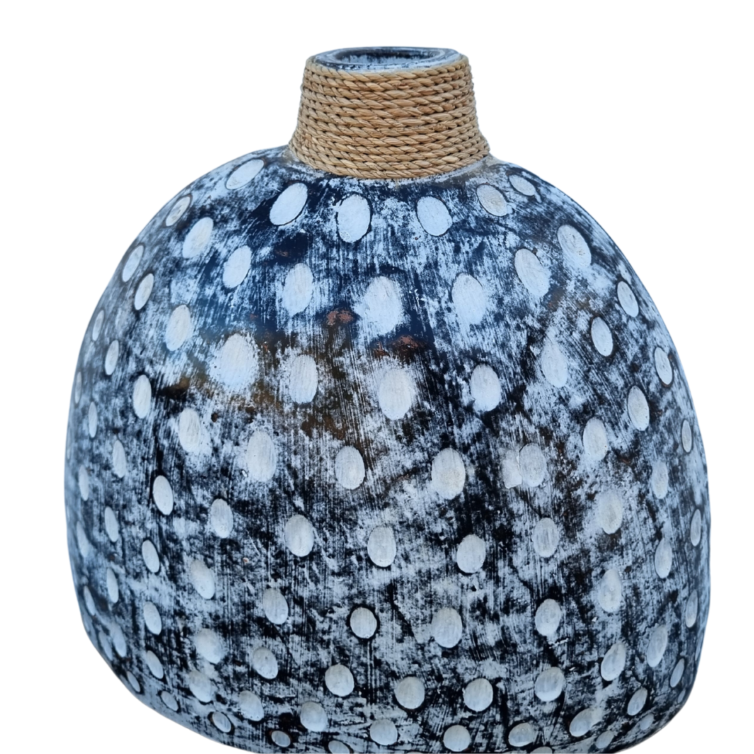 A ceramic table top vase with a black and white wash finish and a jute rope detail on the top.
