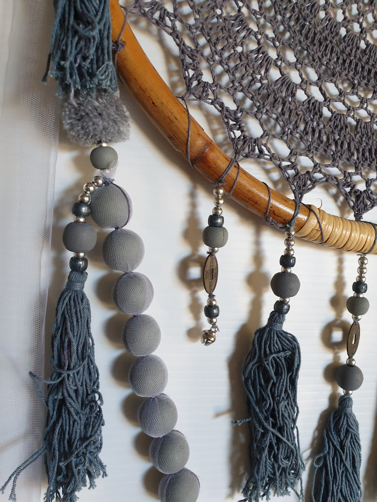 Close-up of the crochet doily pattern, beads and tassels