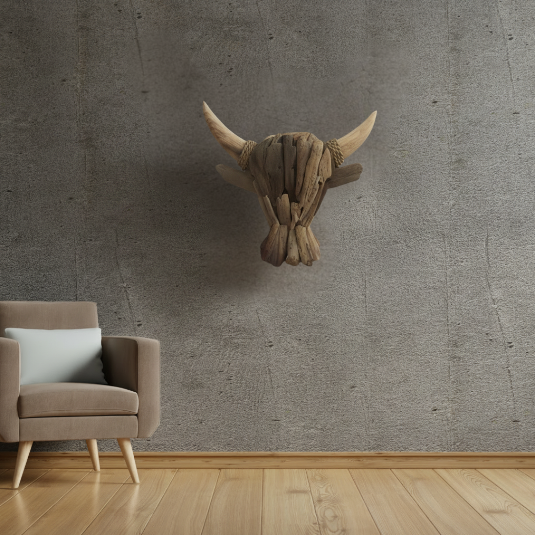 Driftwood buffalo bull head wall art mounted above a modern armchair on a textured concrete wall — rustic boho decor styled in a contemporary living space — Azure Decor