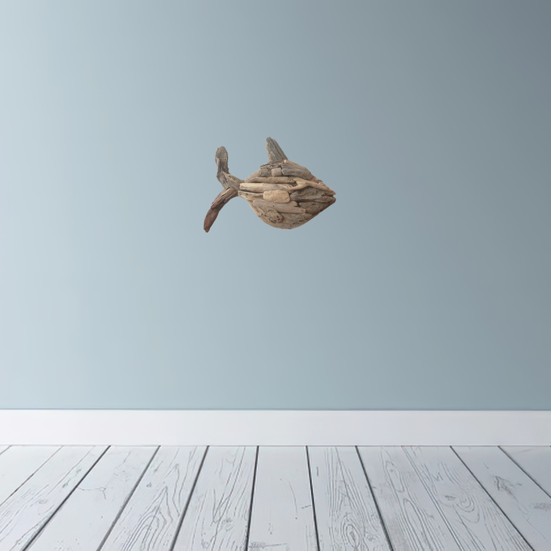 Driftwood sculpture of a fish on a light blue wall with wooden floor.