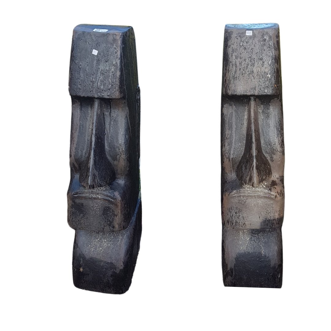 Two stone sculptures resembling faces on a white background