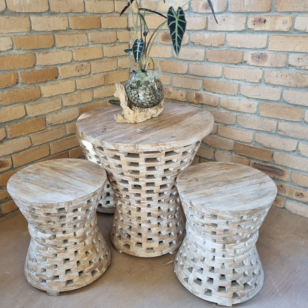 white wash furniture set on a patio with a brink back wall