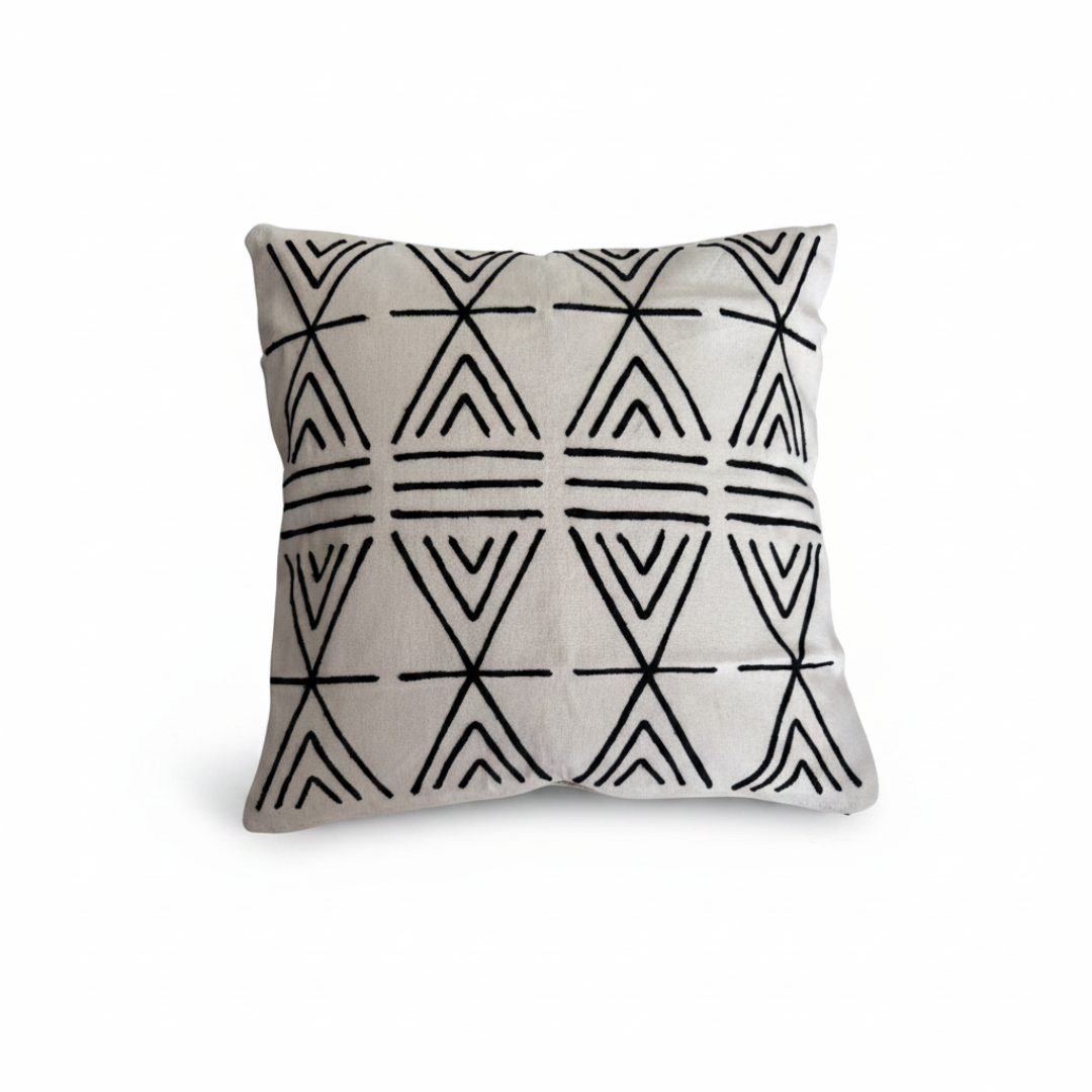 White linen cushion with black embroidered repeating triangle and X cross geometric pattern