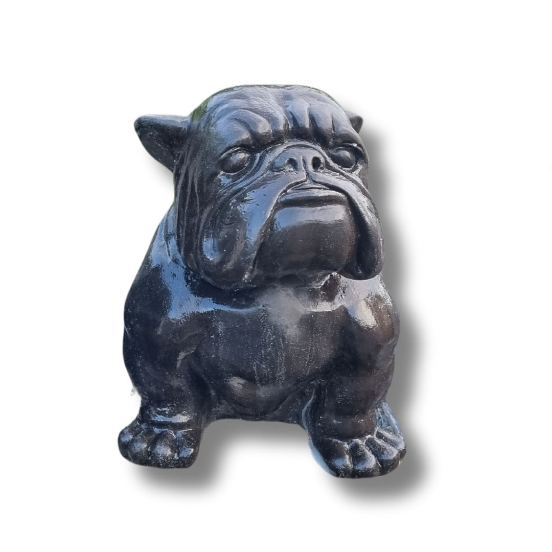Black stone sculpture of a bulldog on a white background