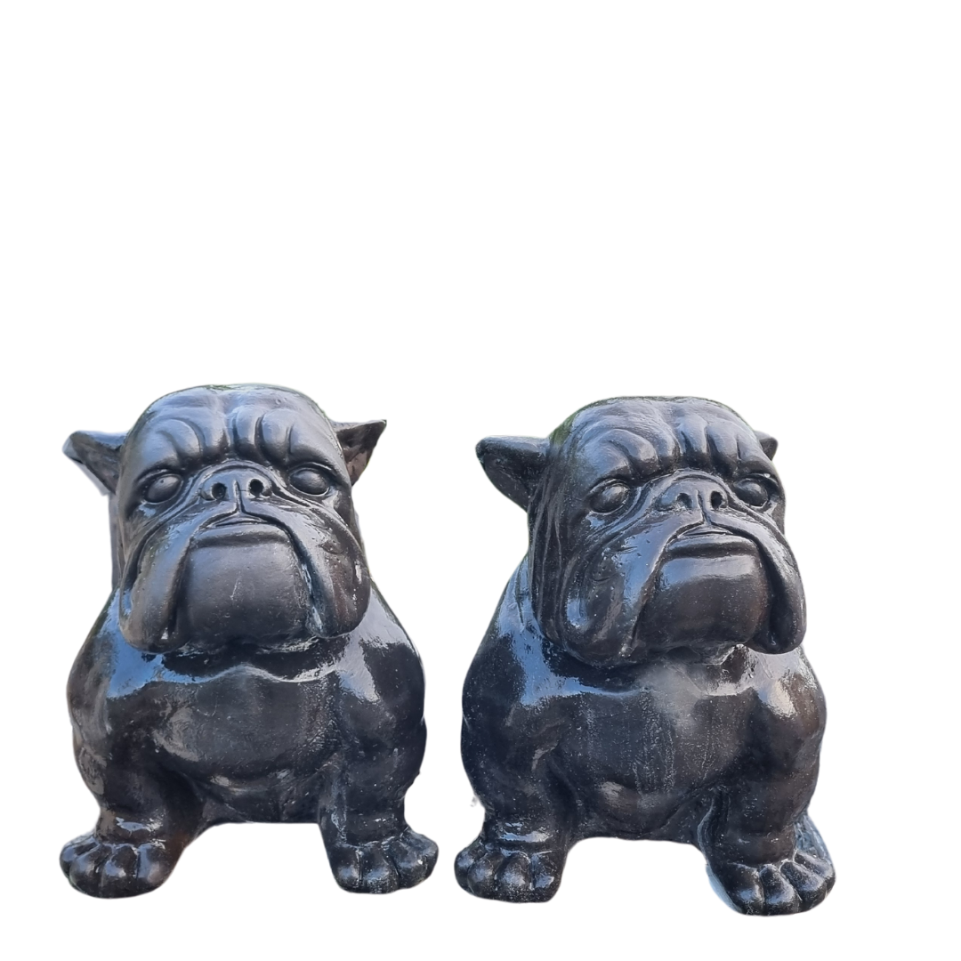 Two black bulldog figurines on a white background