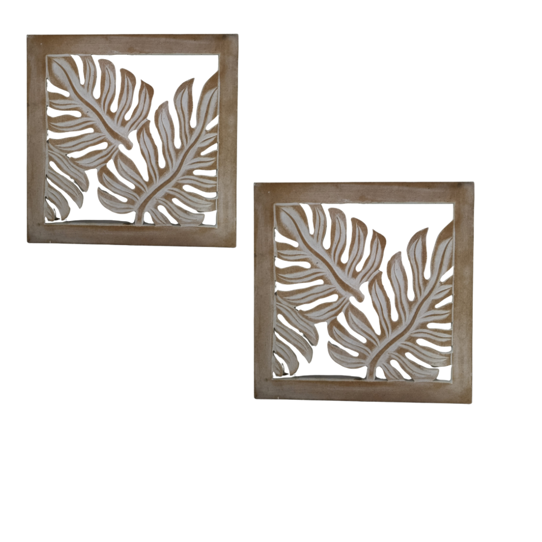 Two square wall art pieces with leaf patterns on a white background