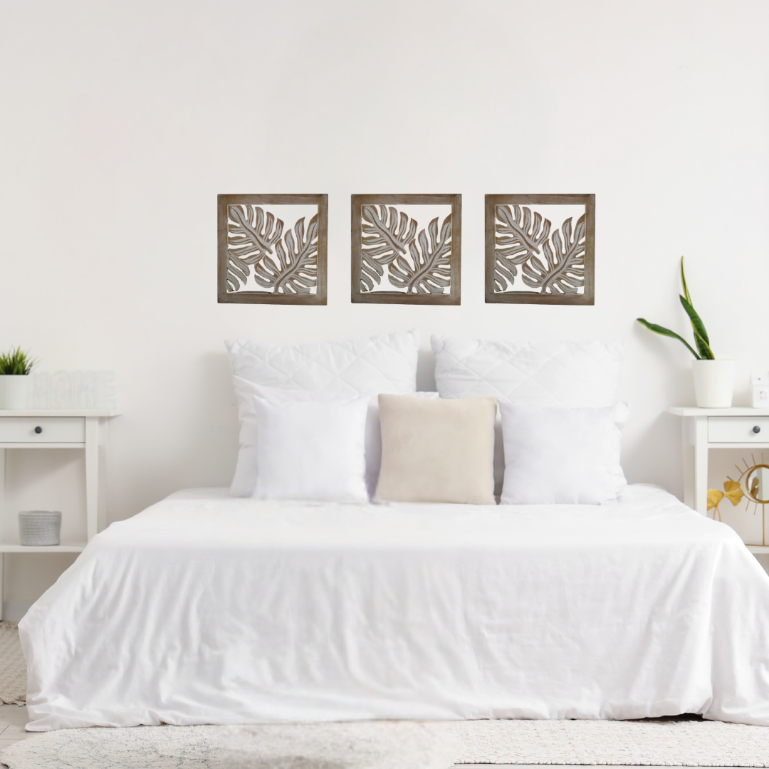 lifestyle shot: "Natural Wash Fern Wall Art displayed above a bed in a bedroom with grey wall