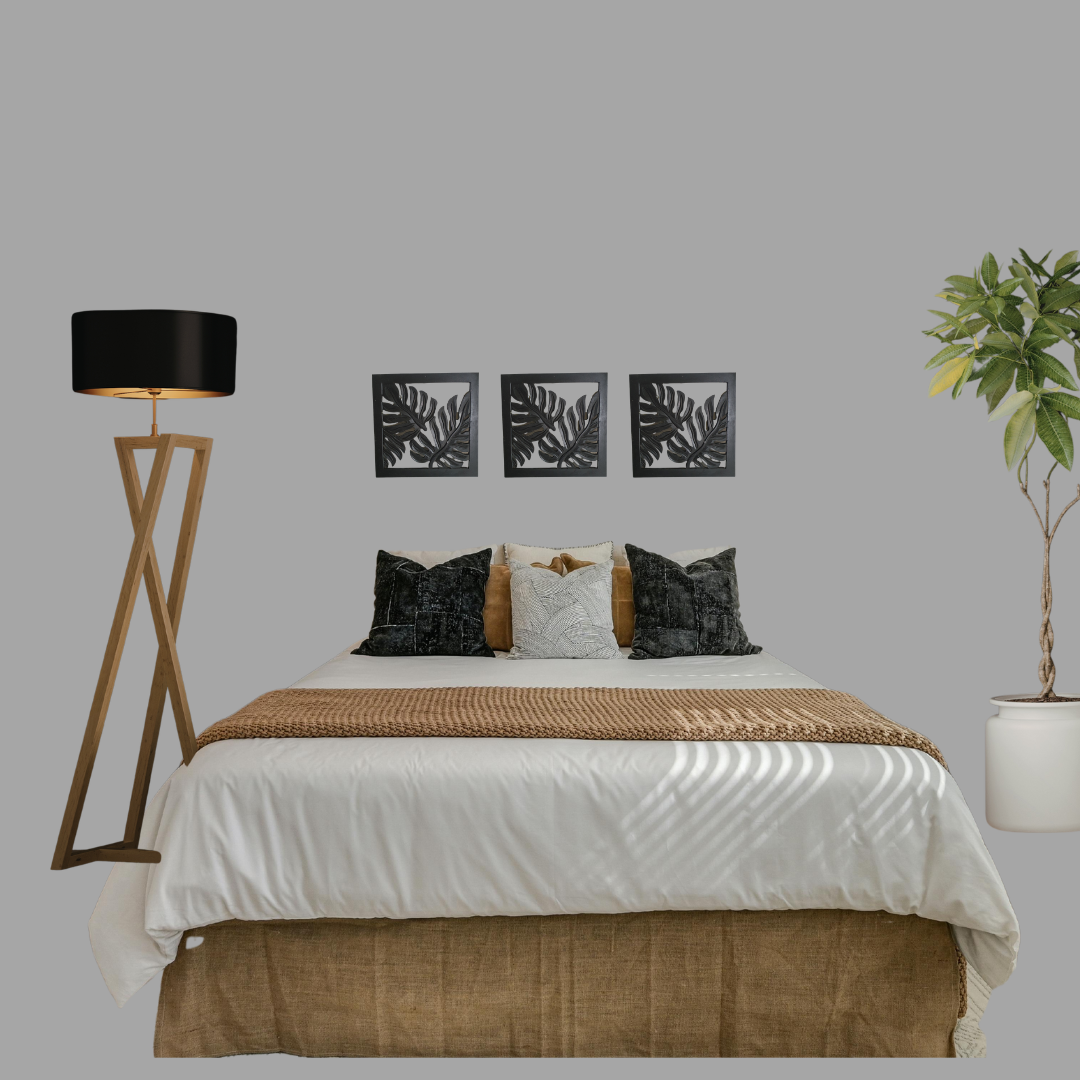 Bedroom with bed, lamp, and wall art on a gray wall