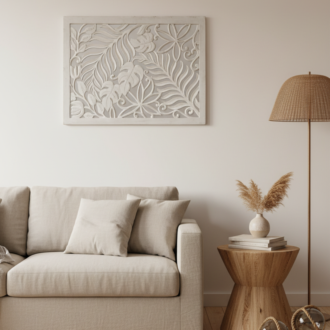 Whitewash carved timber wall art panel hung horizontally above a cream linen sofa in a warm coastal living room, styled with a timber side table, white ceramic vase with dried pampas grass and a rattan floor lamp
