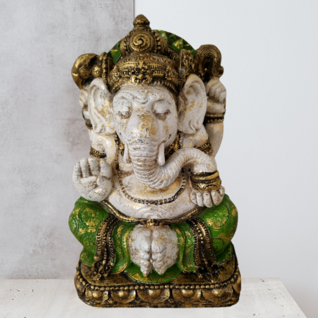 Decorative statue of a deity with green and gold accents on a white background