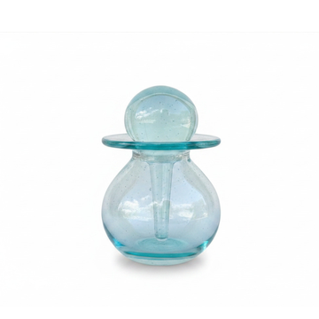Glass oil bottle applicator assembled and closed, front view on white background