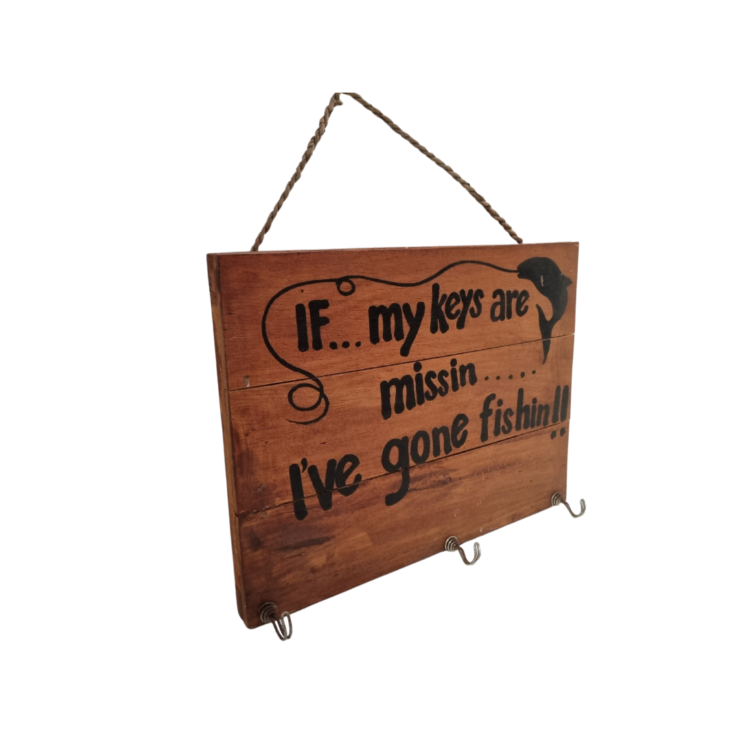 Gone Fishing wooden key holder plaque — angled view showing three metal hooks, timber plank construction and rope hanger