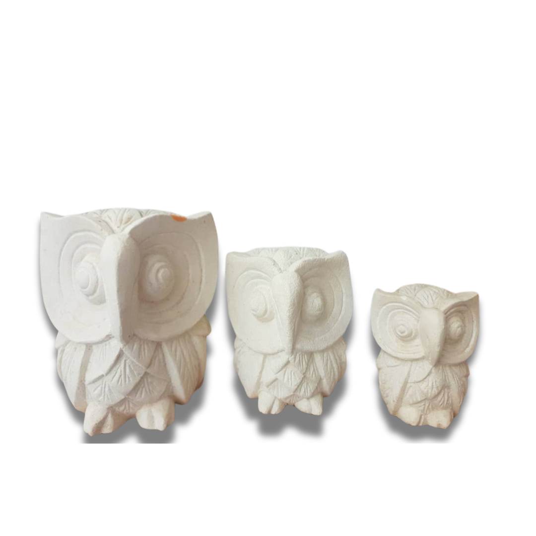 A set of three limestone carvings of owls in decreasing size order, from largest to smallest