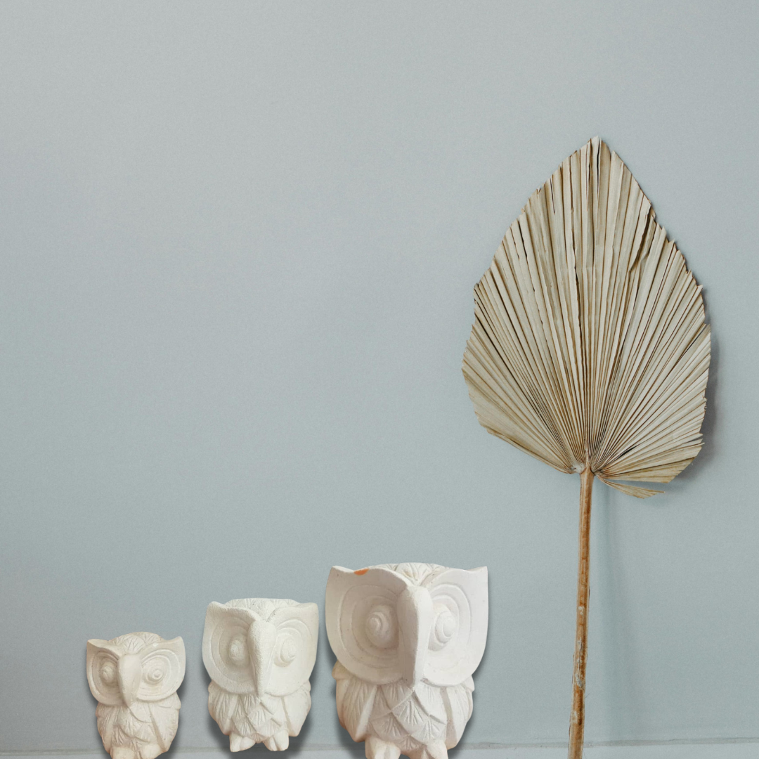 A set of three limestone carvings of owls in decreasing size order, from largest to smallest, living room boho style