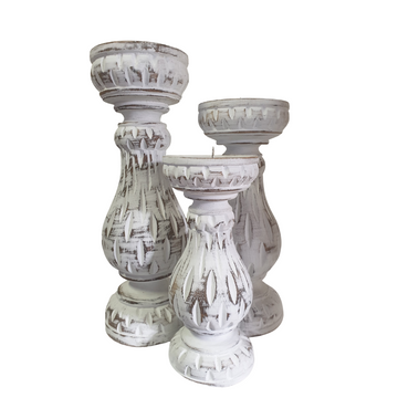 Set of three hand-carved distressed white wooden candle holders on a white background, showing the detailed carving and whitewash finish across all three graduated sizes