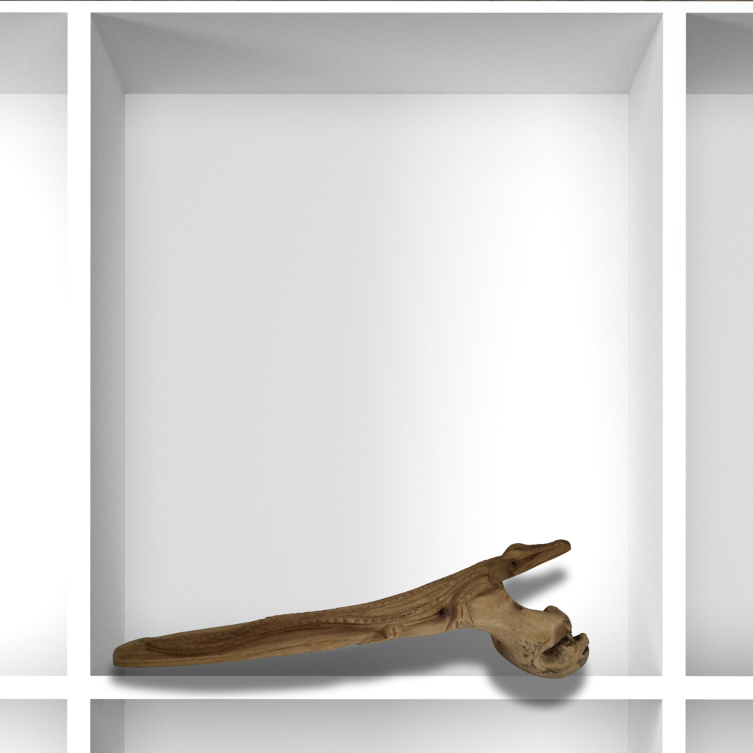 Hand-carved wooden crocodile sculpture on white background showing rustic natural finish.