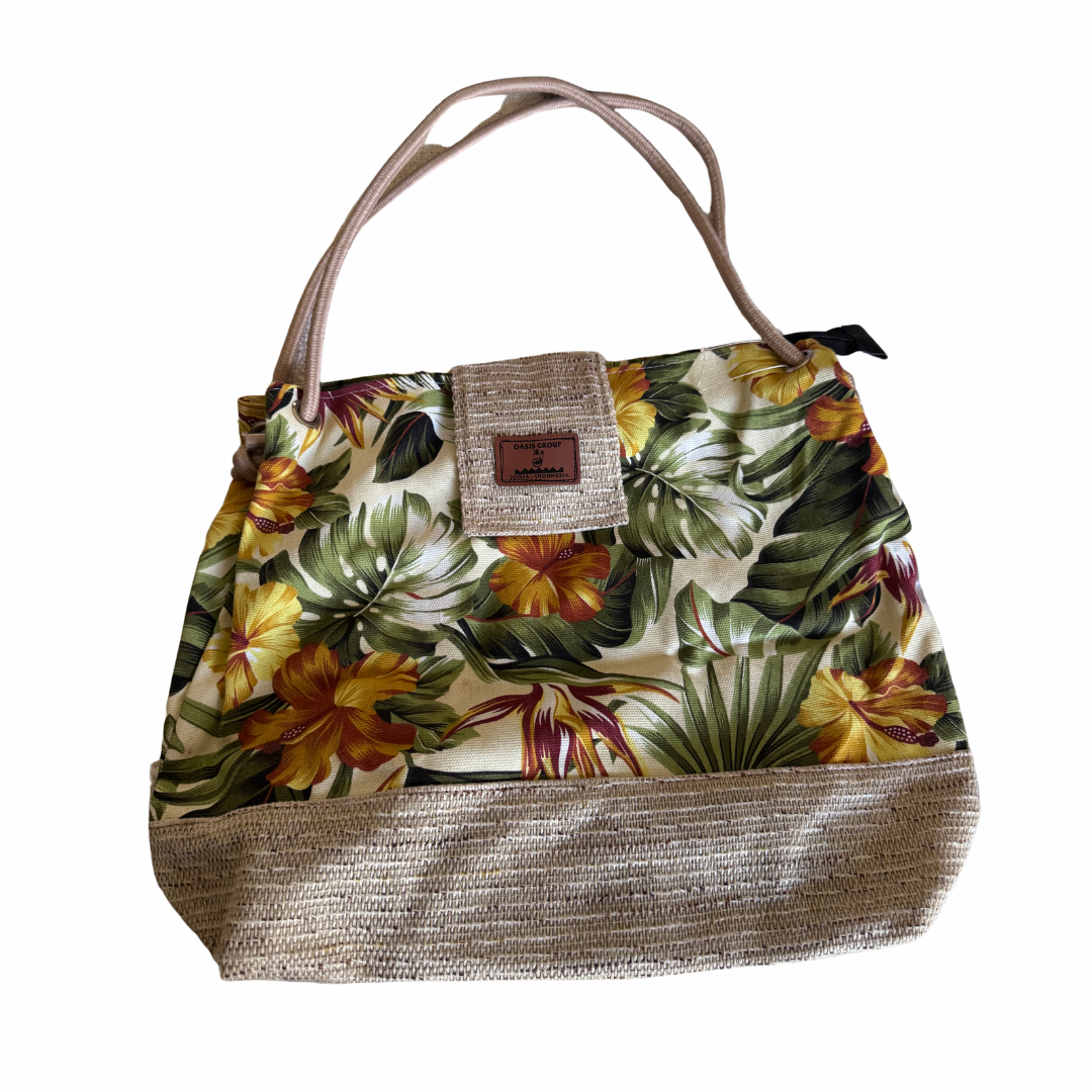 Floral patterned handbag with a textured handle on a white background