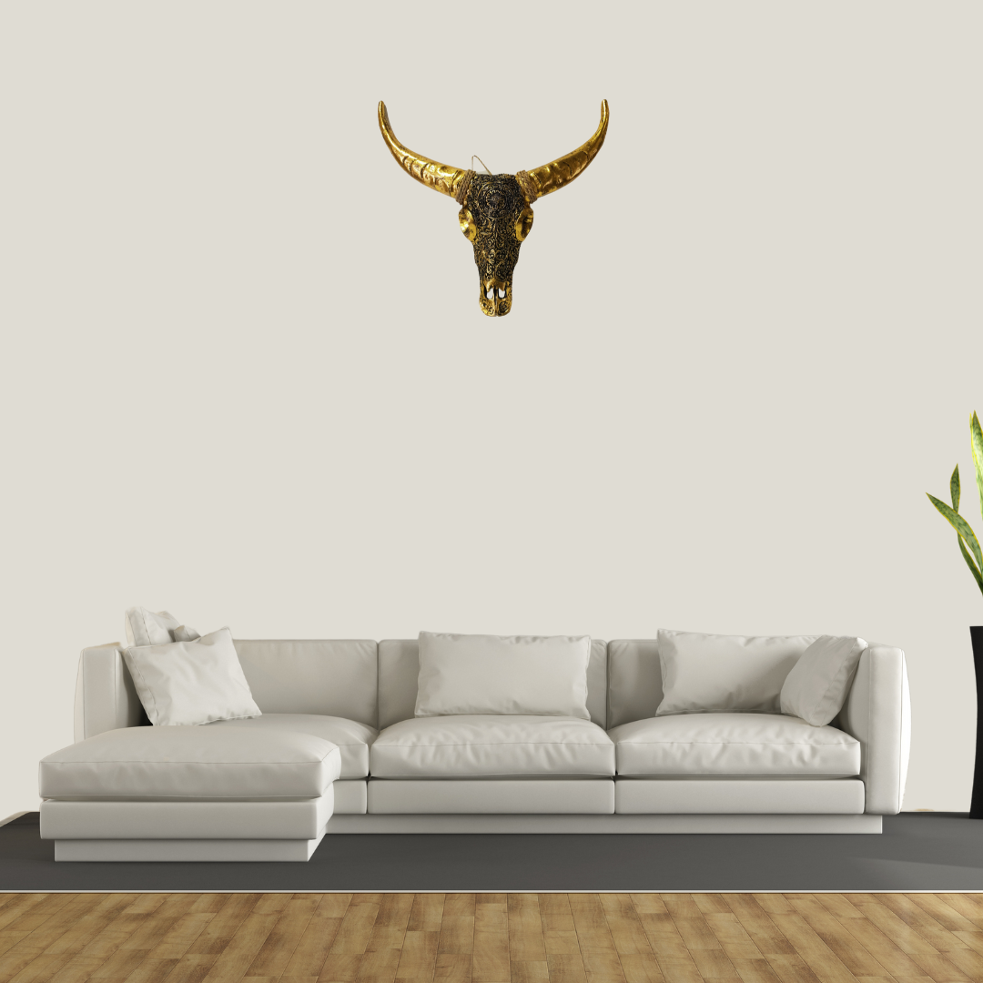 White sectional sofa with a decorative bull skull on a plain wall.