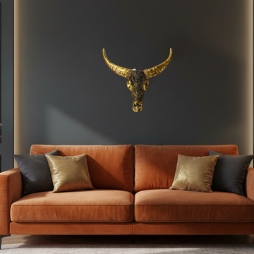 Handcrafted metallic gold bull skull wall art with intricate mandala engraving, styled on a dark feature wall in a luxe boho living room with velvet sofa and warm ambient lighting — Azure Decor Australia