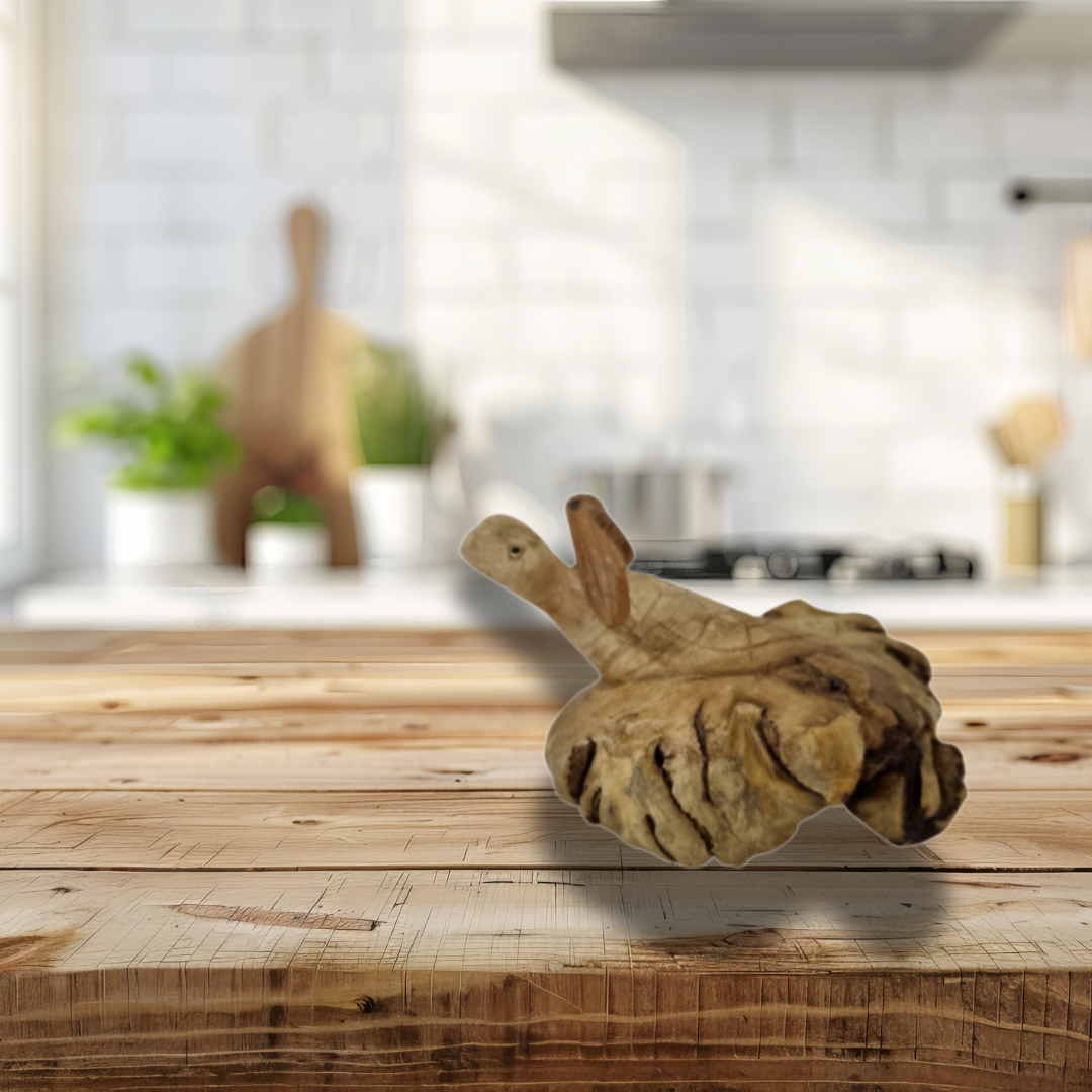 Wooden cutting board with a decorative piece on a wooden table in a kitchen setting