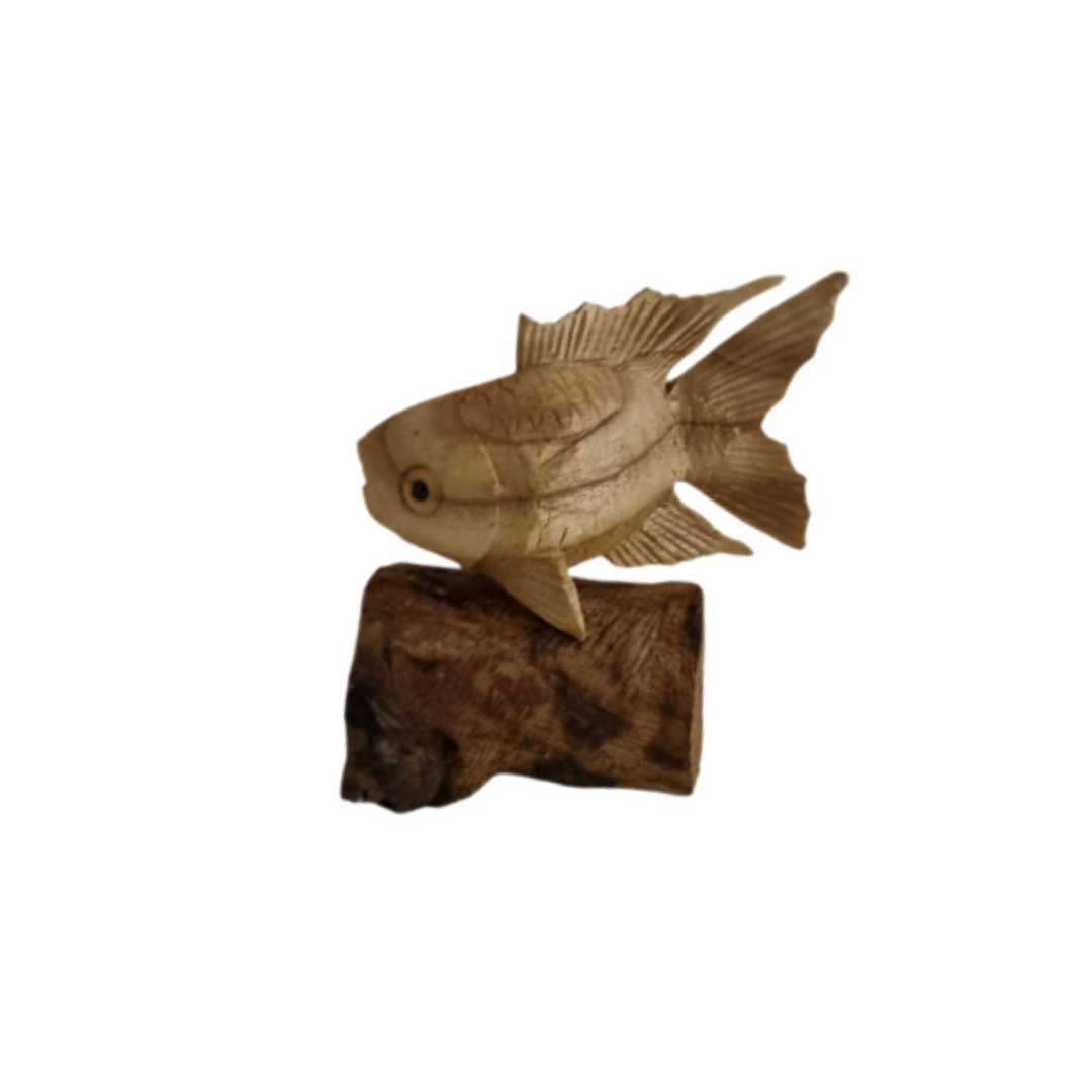 Wooden fish figurine on a rock against a white background