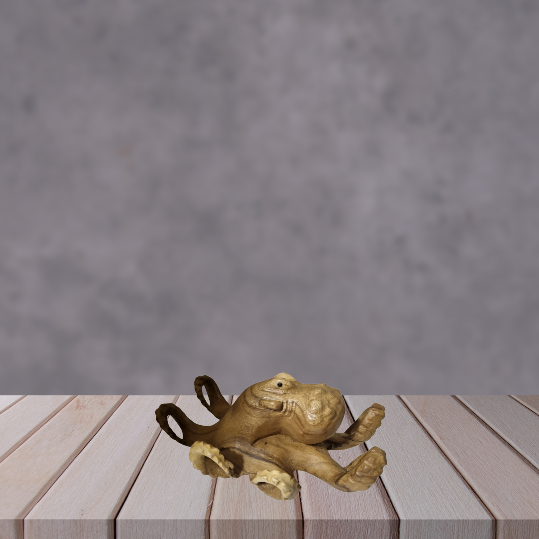 Wooden octopus sculpture on a wooden surface with a gray background