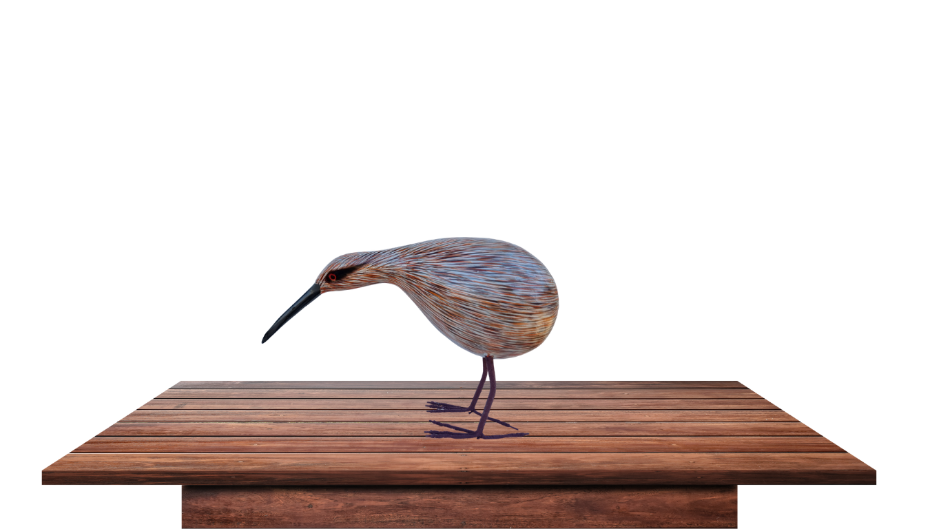 Wooden bird sculpture on a wooden platform with a white background