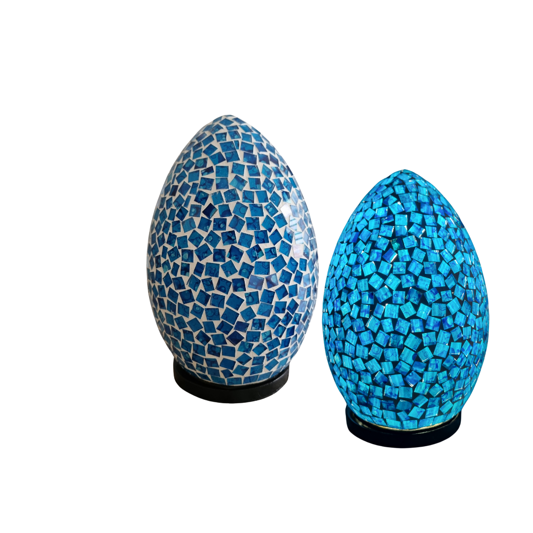 two adorable lamps first is off the other has been turned on for visual effect both on a white back wall 