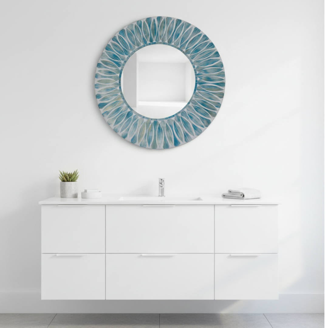 Teal mosaic mirror above white vanity with succulent in coastal bathroom
