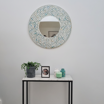Mosaic mirror with Flower of Life design styled above a marble console table with plant and vases — coastal boho entryway decor