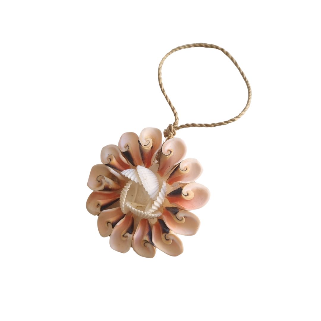 Decorative shell ornament with a string on a white background