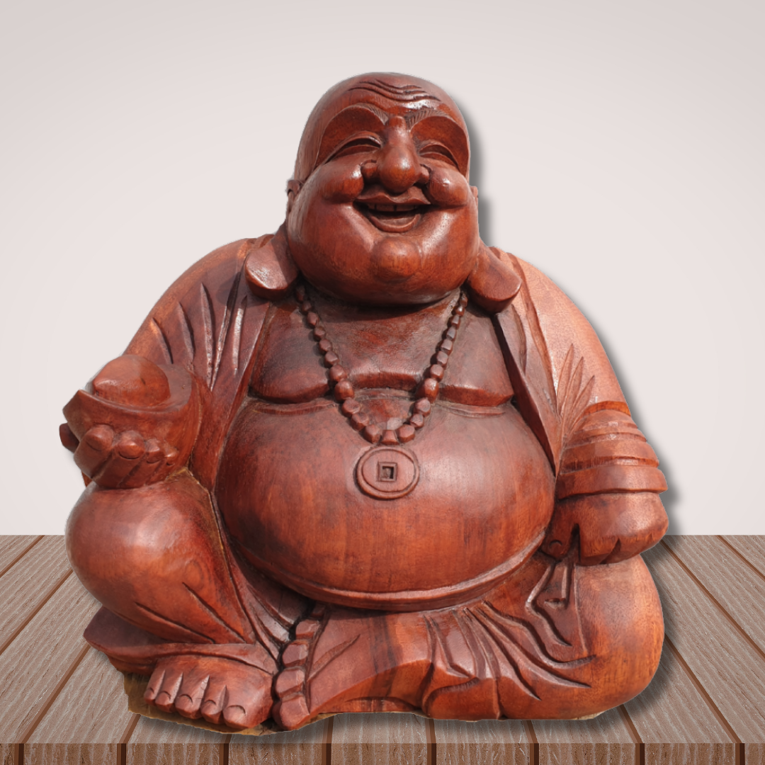 Wooden laughing Buddha statue on a wooden surface with a light gray background