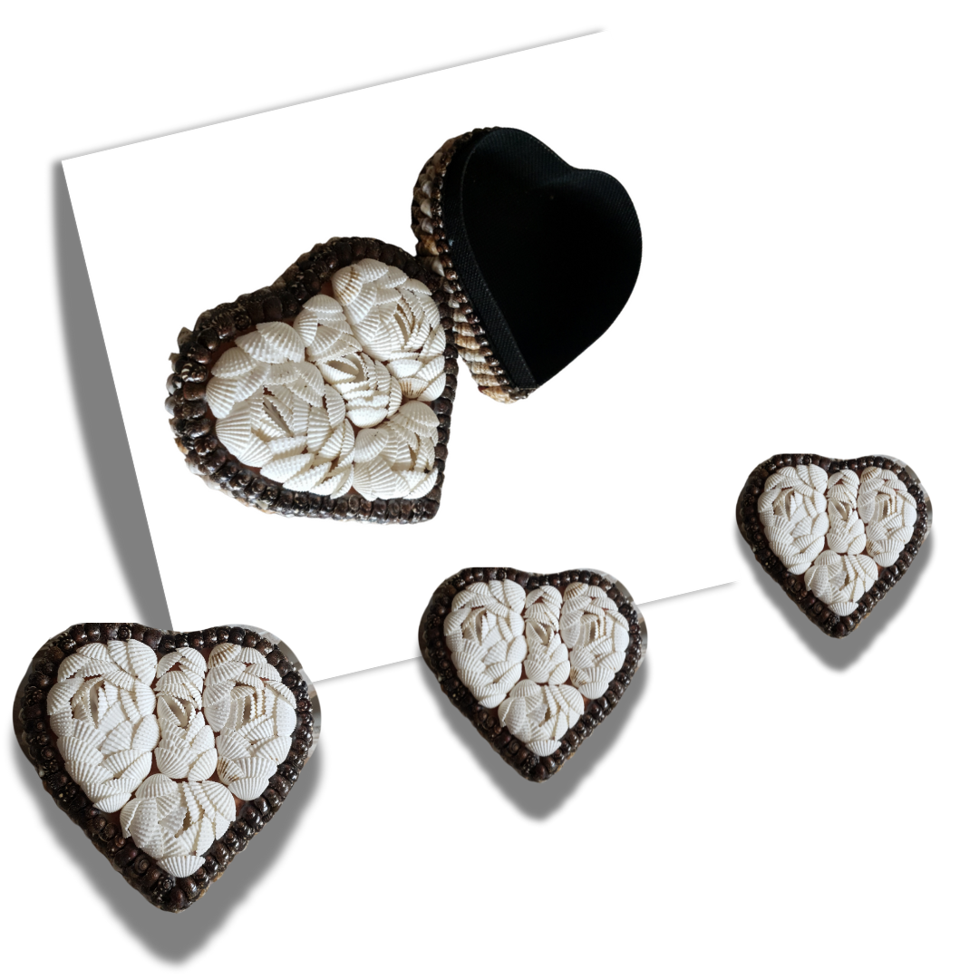 Small heart-shaped shell trinket box closed, showing white shell-covered lid with dark shell finish