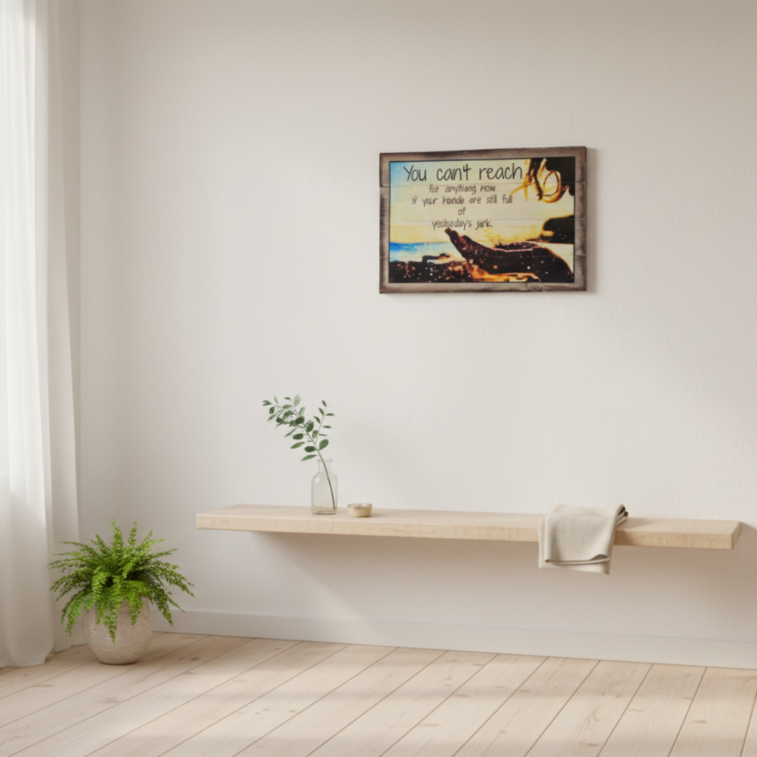Square bright entryway with a framed wall plaque, open window, sheer curtains and fresh greenery