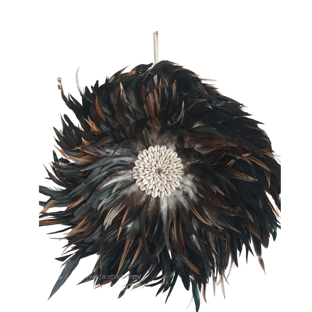 Handcrafted Balinese Juju Hat wall hanging featuring layered dark feathers with a cowrie shell centre. Boho-inspired wall décor measuring 40–50cm, perfect for adding texture and natural coastal style to any room.