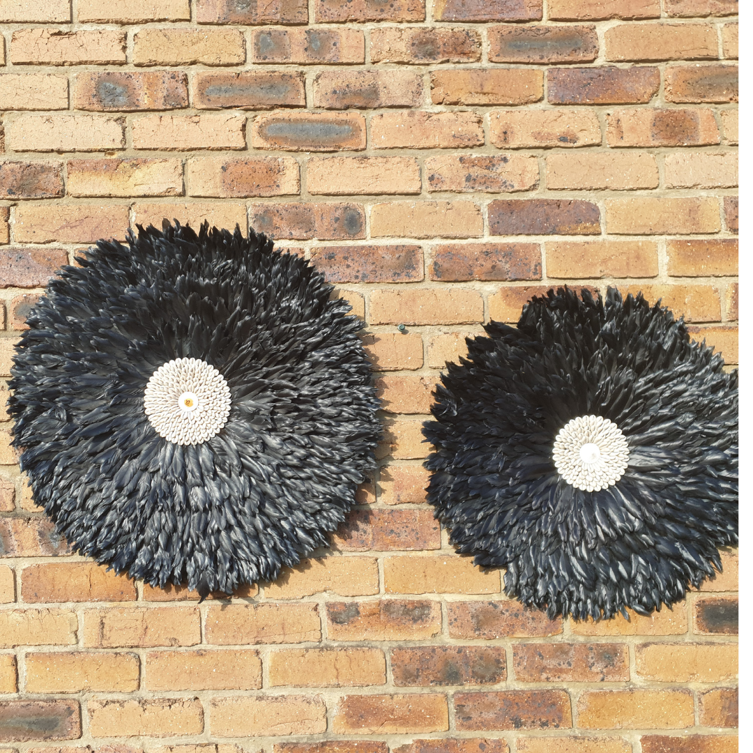 black colour juju feather art large and medium on a brick wall 
