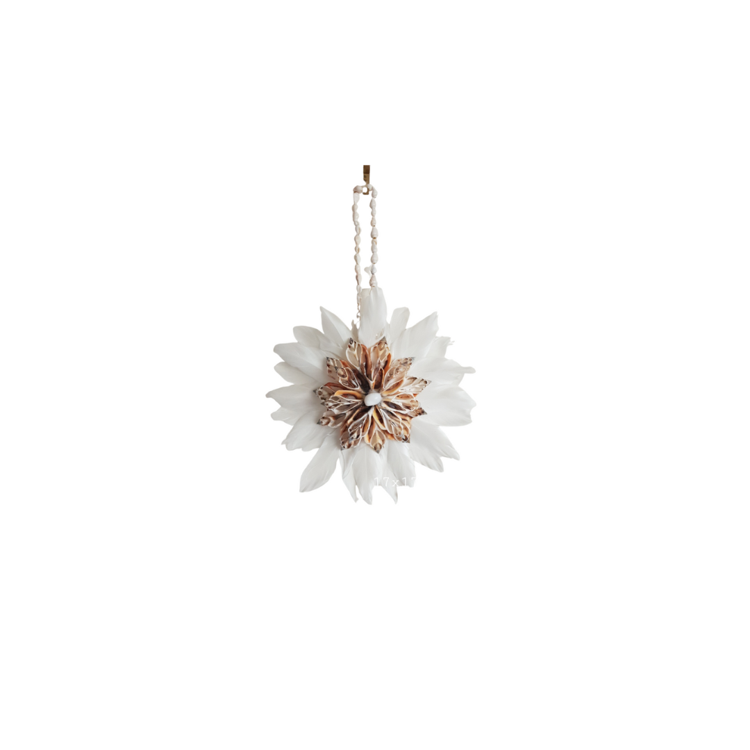 Decorative hanging flower with white petals and gold center on a white background