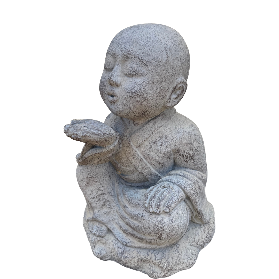 Side profile of a grey seated figurine with pursed lips, an upturned palm and draped robes