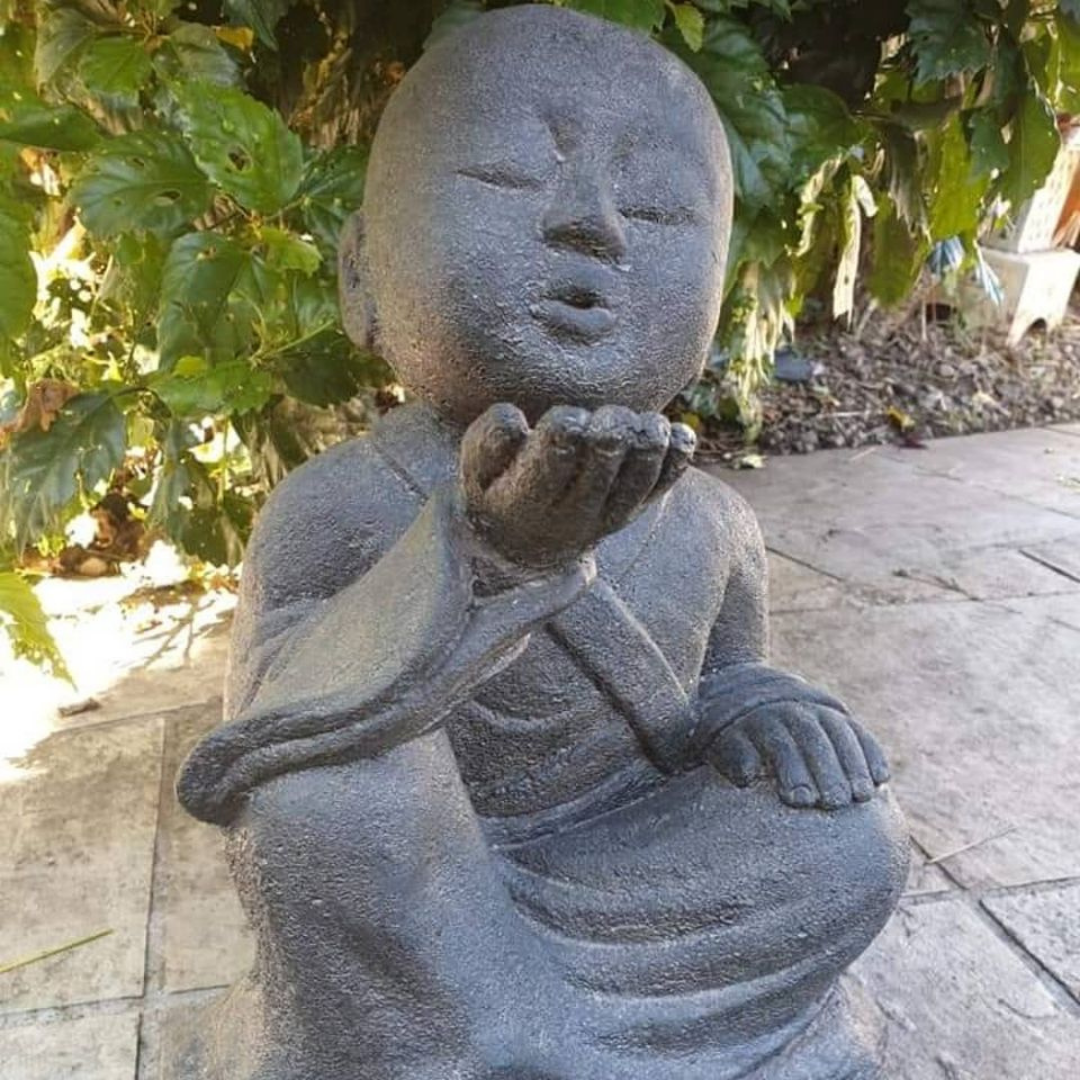 closeup view on the 38cm garden statue set on a path infront of a true 